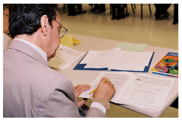 Image of man writing in a notebook